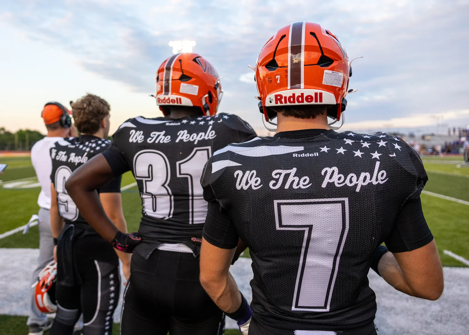 Teammates looking on from the sidelines